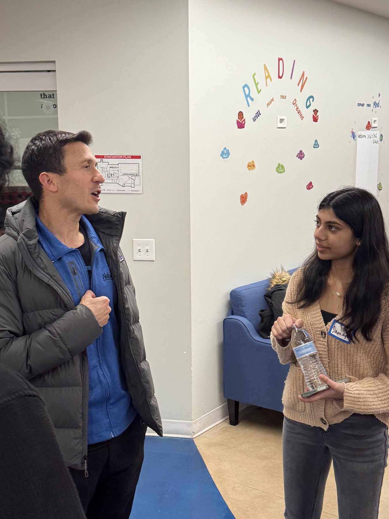 A student in conversation with Jeff Braverman at the Boys & Girls Club of Newark